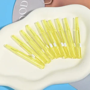 Push-pull type interdental brushes with yellow transparent handles, compact sliding design for easy storage and hygiene, suitable for dental care brands and B2B wholesale supply.