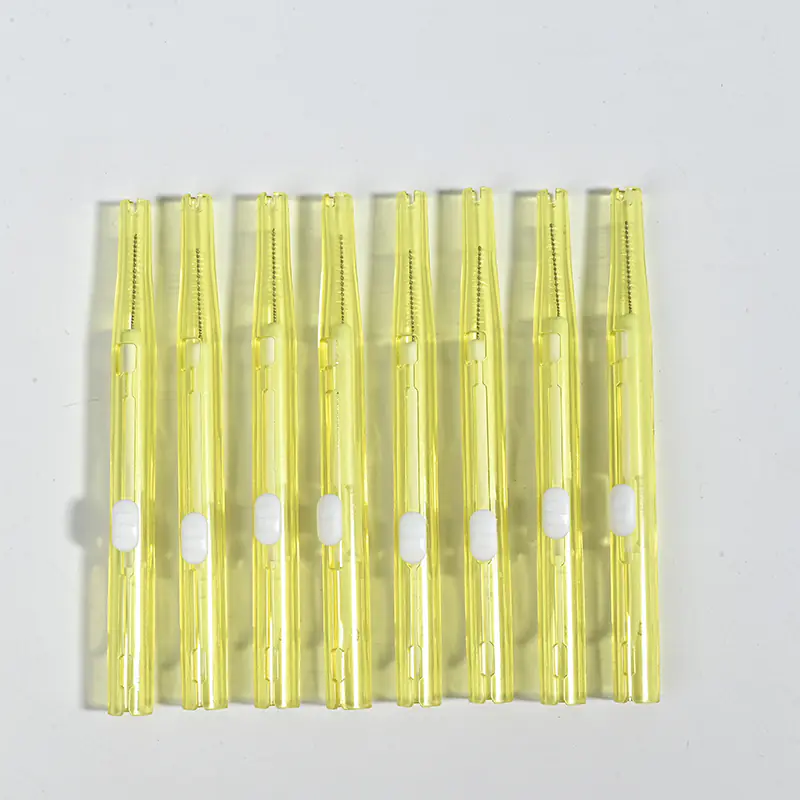 Push-pull type interdental brushes with yellow transparent handles, compact sliding design for easy storage and hygiene, suitable for dental care brands and B2B wholesale supply.