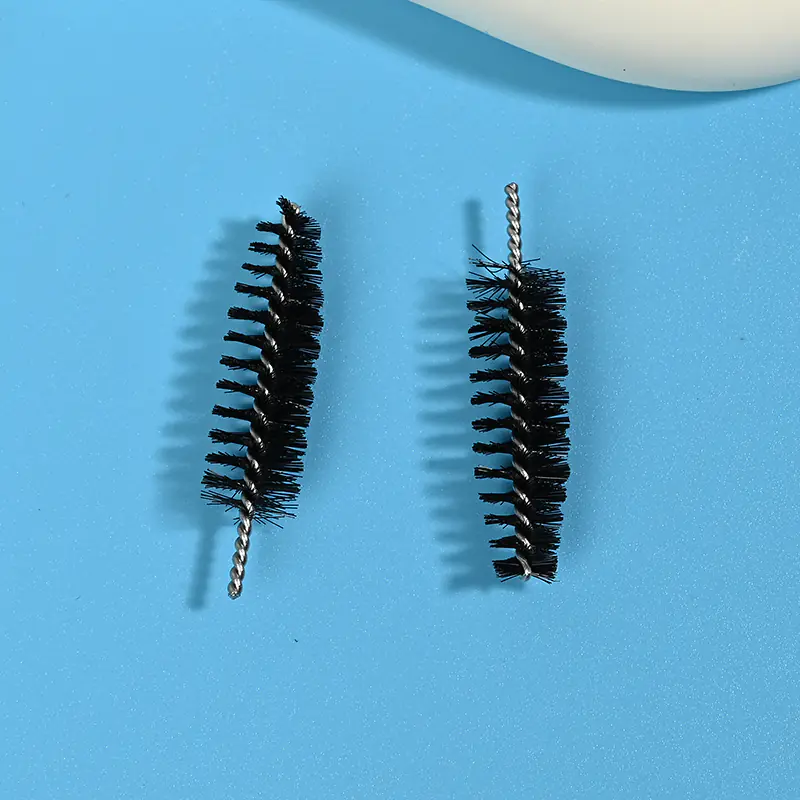Black mascara brush heads with dense spiral bristles and twisted metal wire core, designed for professional eyelash application, OEM manufacturing, and bulk B2B cosmetic supply.