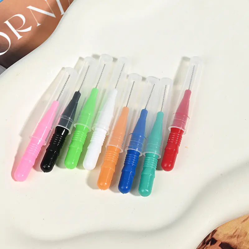 close-up of single multi-color i-type interdental brushes with protective caps