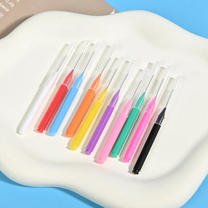 close-up of single multi-color i-type interdental brushes with protective caps
