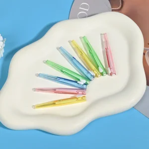 close-up of multi-color retractable interdental brushes in different positions