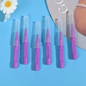 Close-up of single-use purple interdental brushes with protective caps for orthodontic and implant cleaning