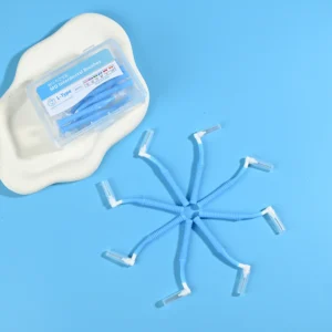Single blue L-type MD interdental brushes arranged in star shape with original clear storage box on beige pad and blue background