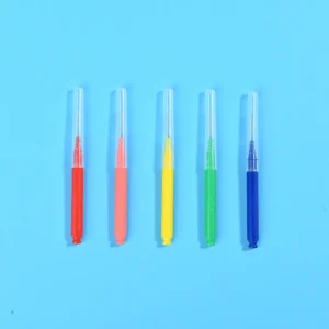 Five color coded I-type interdental brushes with transparent protective caps vertically arranged on light blue background, wholesale dental supplies from Qingdao factory