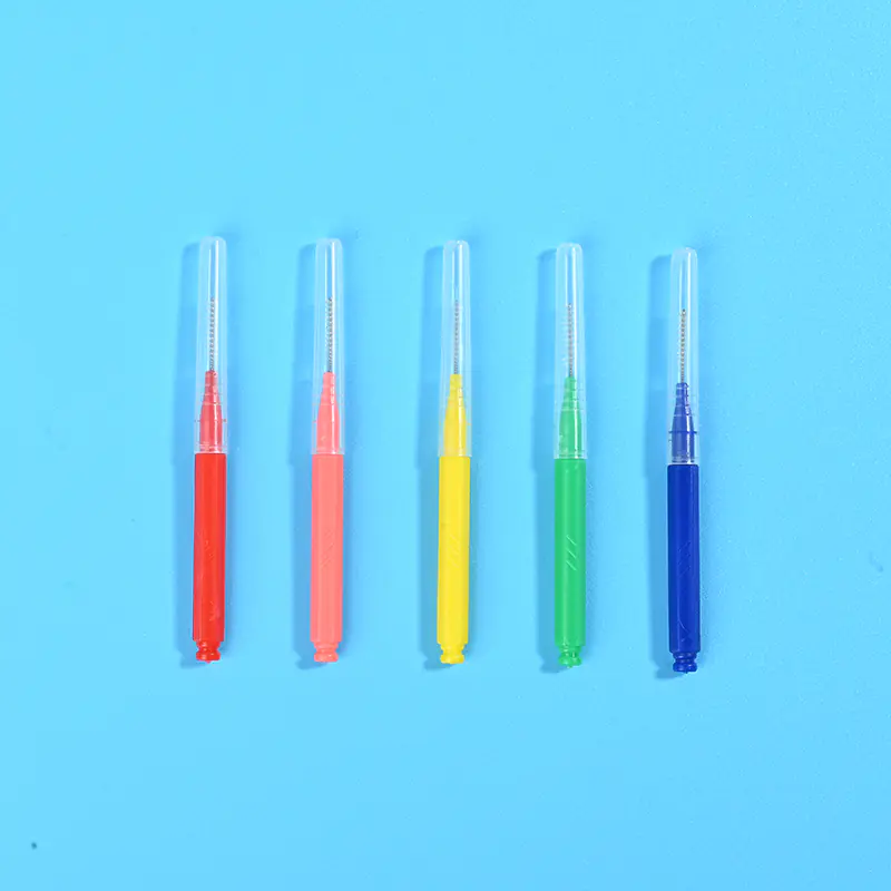 Five color coded I-type interdental brushes with transparent protective caps vertically arranged on light blue background, wholesale dental supplies from Qingdao factory