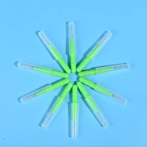 Nine green disposable interdental brushes with transparent protective caps arranged radially on light blue background