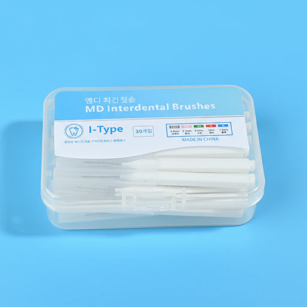 Packaged I-type MD interdental brushes with clear plastic storage box on plain white background, 30-count disposable teeth gap cleaning brushes for B2B dental wholesale