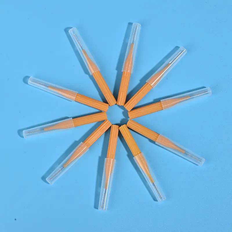 Orange I-type interdental brushes with protective caps arranged in star shape, wholesale dental cleaning tools from Qingdao factory