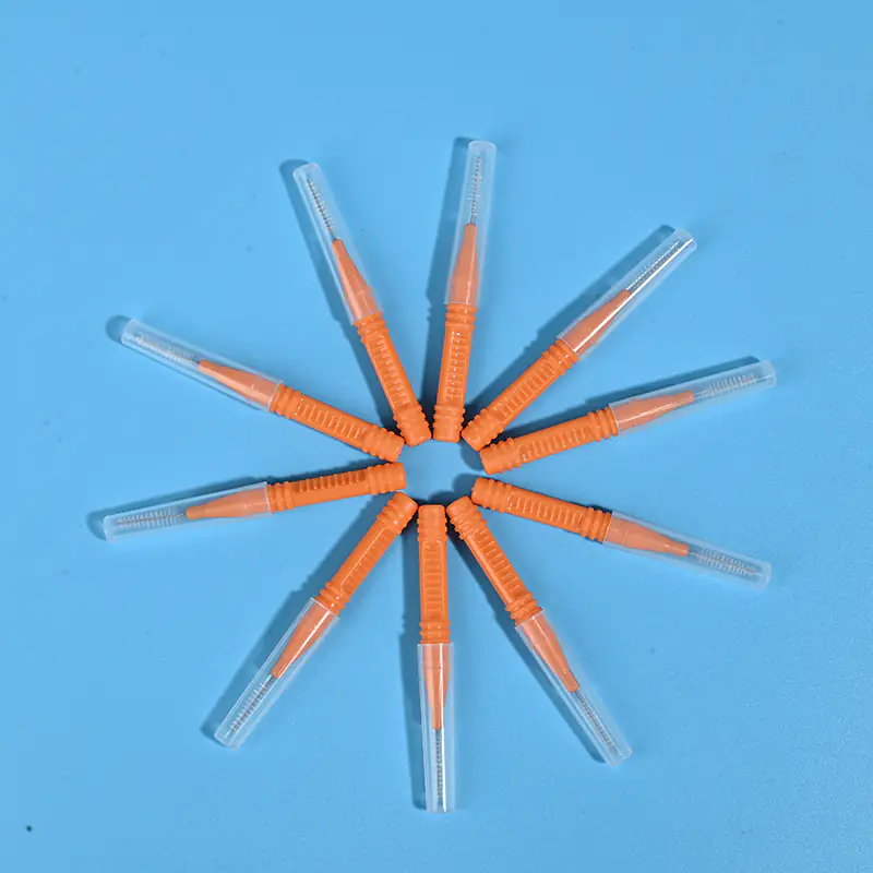 Orange I-type interdental brushes with protective caps arranged in star shape, wholesale dental cleaning tools from Qingdao factory