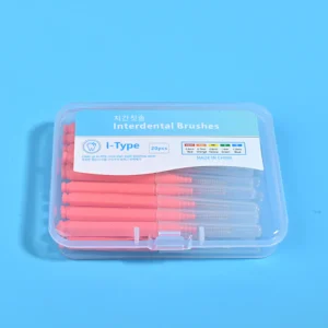 Pink straight I-type interdental cleaners arranged radial star shape with clear plastic box and orthodontic bracket dental model on beige irregular pad and bright blue background