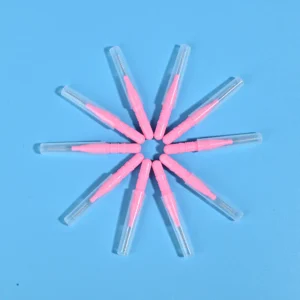 Nine pink disposable interdental brushes with transparent protective caps arranged radially on light blue background