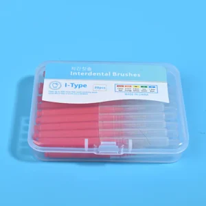 Close-up transparent plastic box filled with red straight I-type interdental brushes, bilingual Korean English label with ISO size color chart on solid blue background