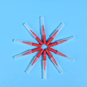 Nine red interdental brushes with transparent protective caps arranged radially on light blue background