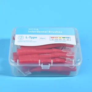 Close-up of transparent plastic box filled with red L-type interdental brushes, bilingual Korean English label with full ISO size specification chart on solid light blue background