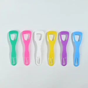 Six assorted colorful plastic tongue scrapers arranged in a straight row on solid white background