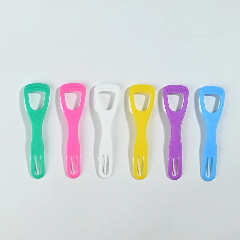 Six assorted colorful plastic tongue scrapers arranged in a straight row on solid white background