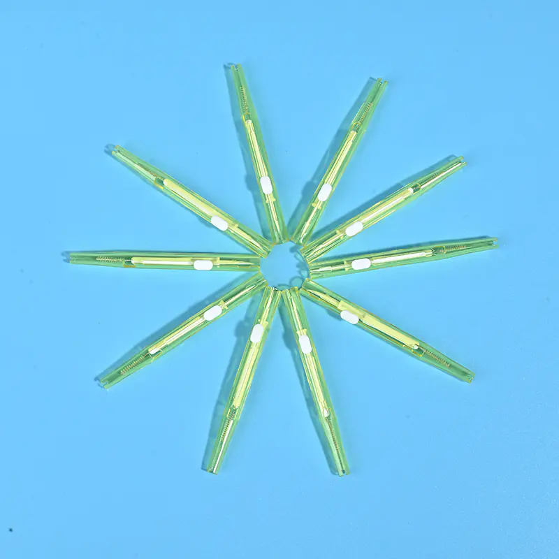 Transparent lime green sliding push-pull I-type interdental brushes arranged radial star shape on solid light blue background