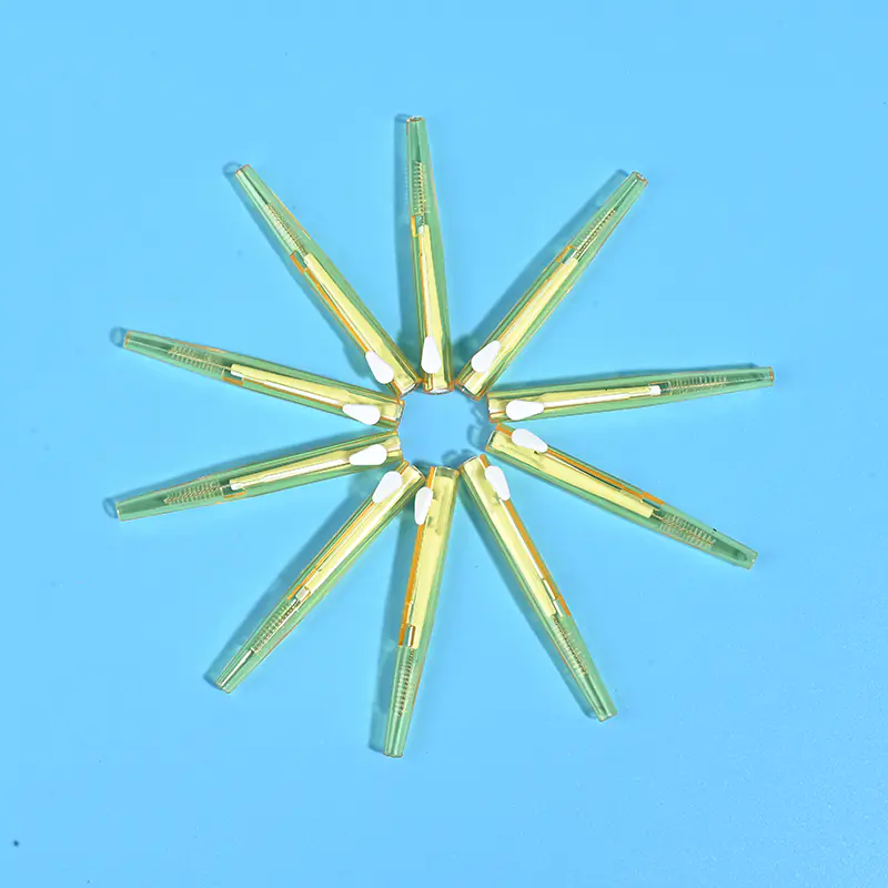 Transparent yellow sliding push retractable I-type interdental brushes arranged radial star shape on solid light blue background