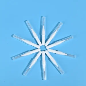 Nine white disposable interdental brushes with transparent protective caps arranged radially on light blue background
