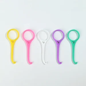 Five different color plastic invisible braces remover hooks lined up side by side on plain white background