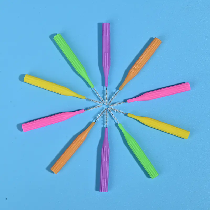 Five bright color I-type interdental brushes with transparent protective caps arranged horizontally, ISO size coded dental wholesale supplies from Qingdao factory