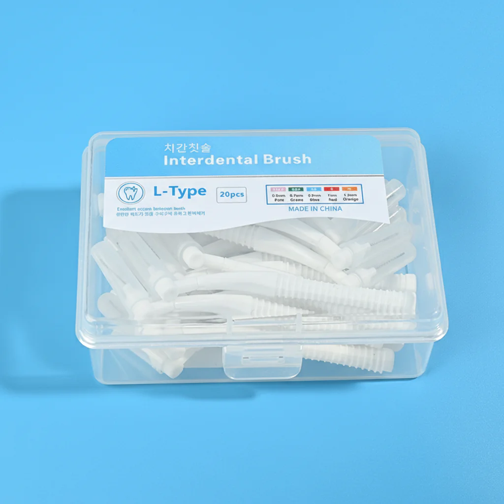 2-white-l-type-interdental-brush-20pcs-clear-box-closeup-blue-bg.jpg Clear plastic storage box full of white L-curved interdental brushes with bilingual Korean English sticker on solid bright blue background