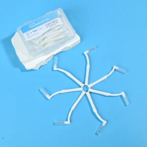 White curved L-type interdental cleaners arranged radial star shape with clear plastic box and irregular white stone pad on light blue background