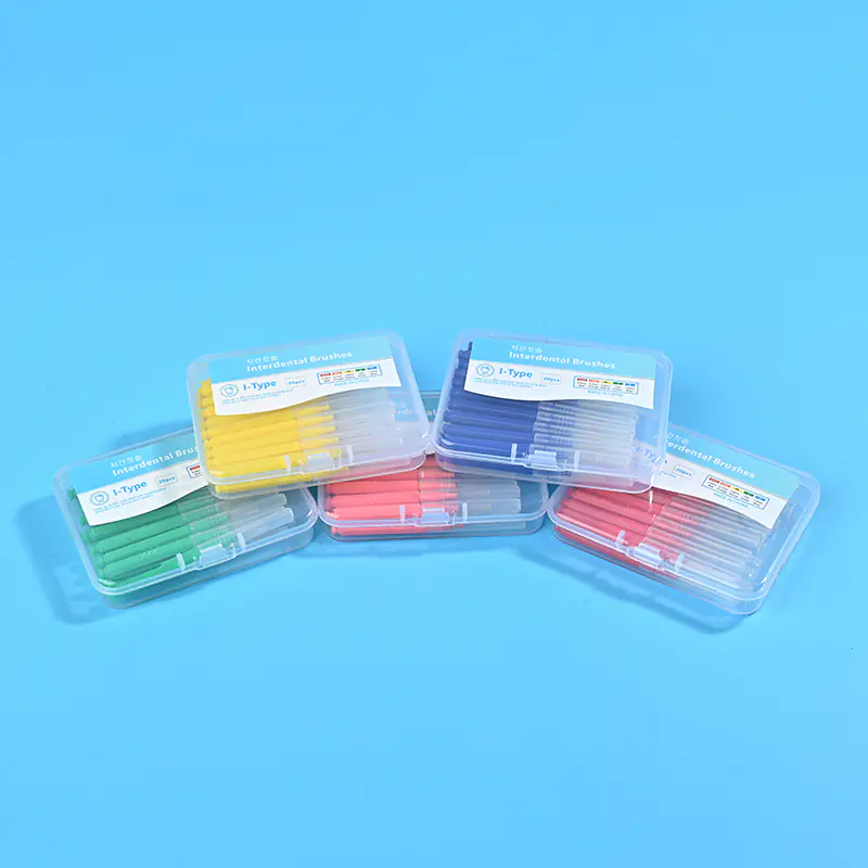 4-multi-color-i-type-interdental-brush-box-stack-five-kinds-blue-background.jpg Five different color clear plastic boxes of I-type interdental brushes stacked together on solid light blue background