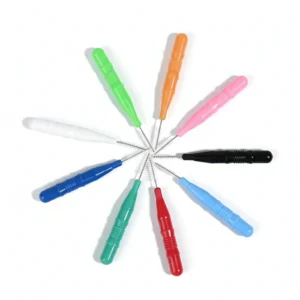 Multiple colored disposable interdental brushes arranged radially on pure white background