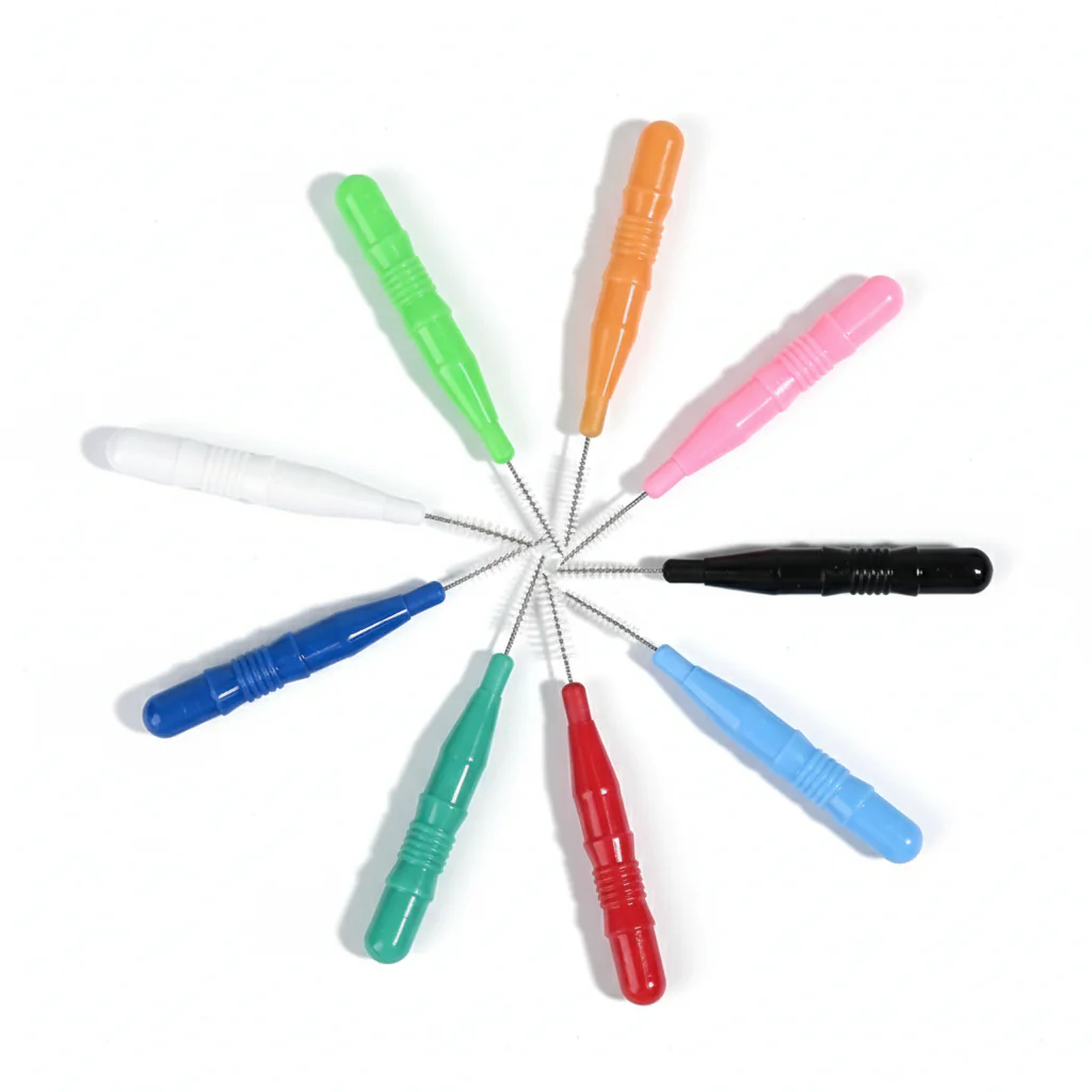 Multiple colored disposable interdental brushes arranged radially on pure white background