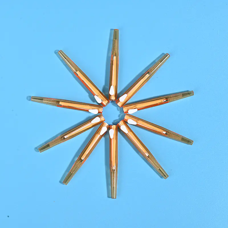 5-amber-orange-transparent-sliding-interdental-brushes-star-arrangement-blue-bg.jpg Amber orange translucent sliding I-type interdental brushes arranged radial star shape on solid light blue background