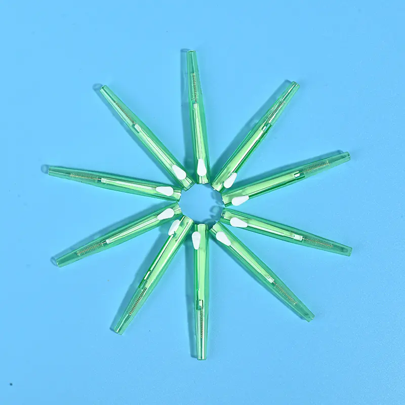 6-transparent-green-sliding-i-type-interdental-brushes-star-layout-blue-bg.jpg Transparent fresh green sliding push interdental brushes arranged radial star shape on solid light blue background